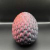 Gemstone egg for fantasy creatures in the color red/black